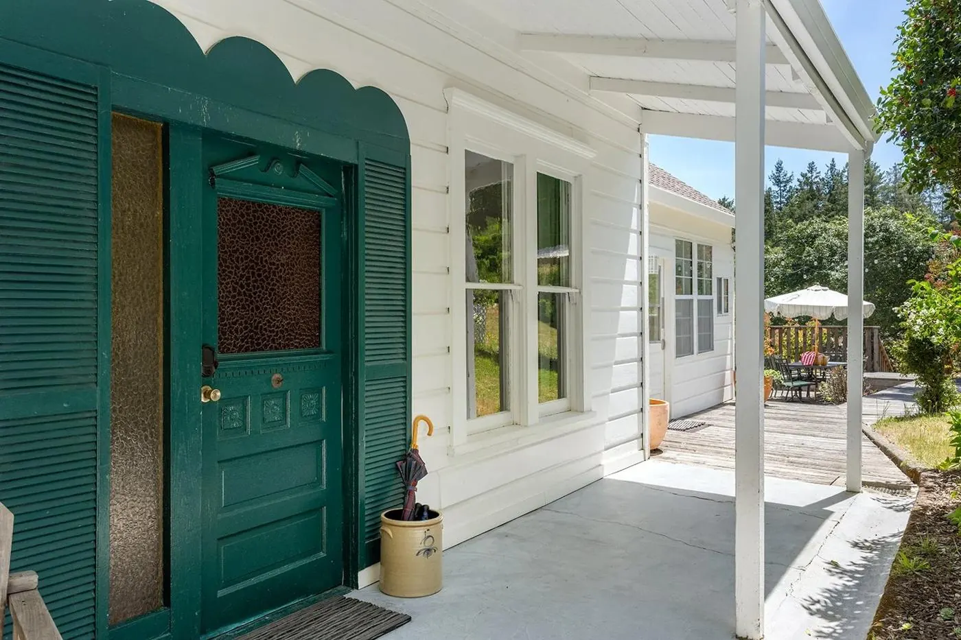 The scalloped green doorway on the front porch